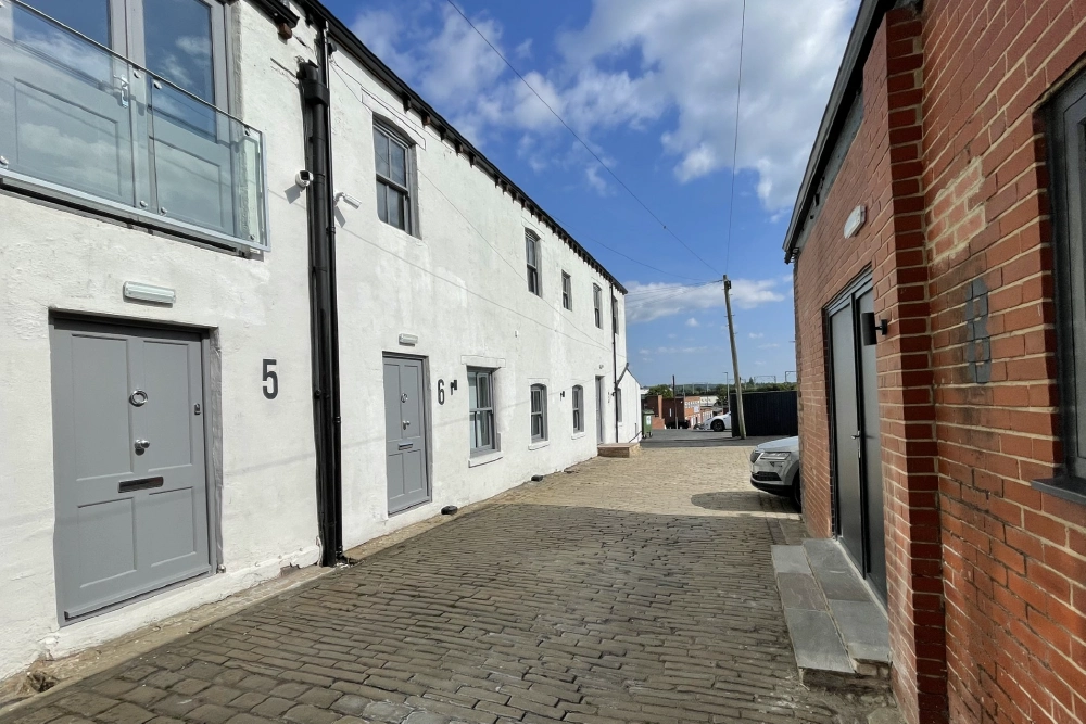 White and brick commercial units lining Elephant and Castle Yard
